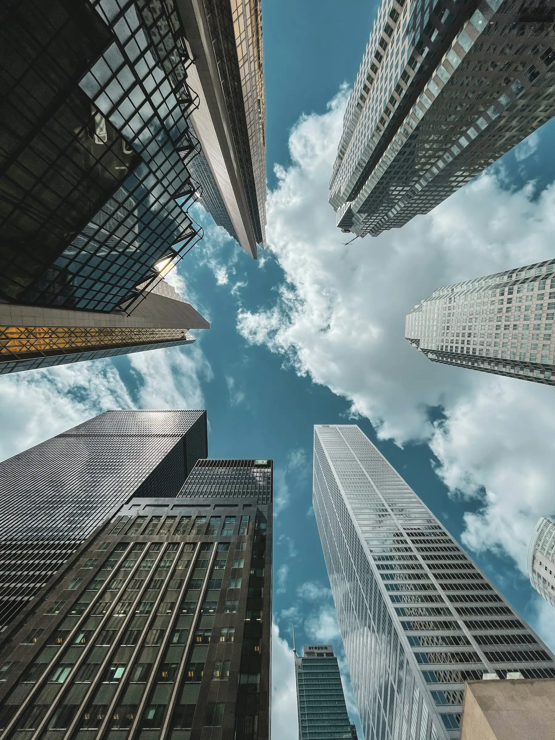 Office towers rising into a blue sky